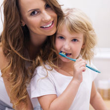 Mom with child brushing teeth
